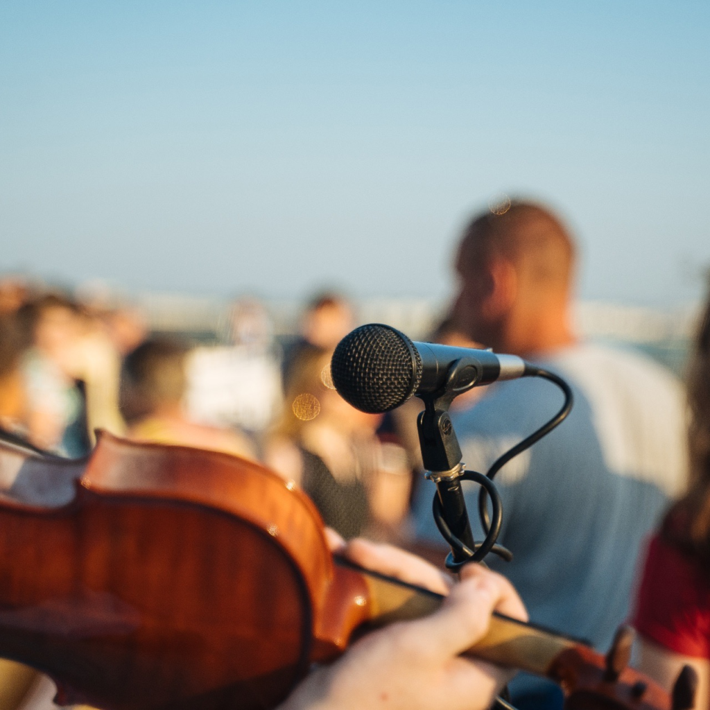 A microphone captures live music at a wedding ceremony
